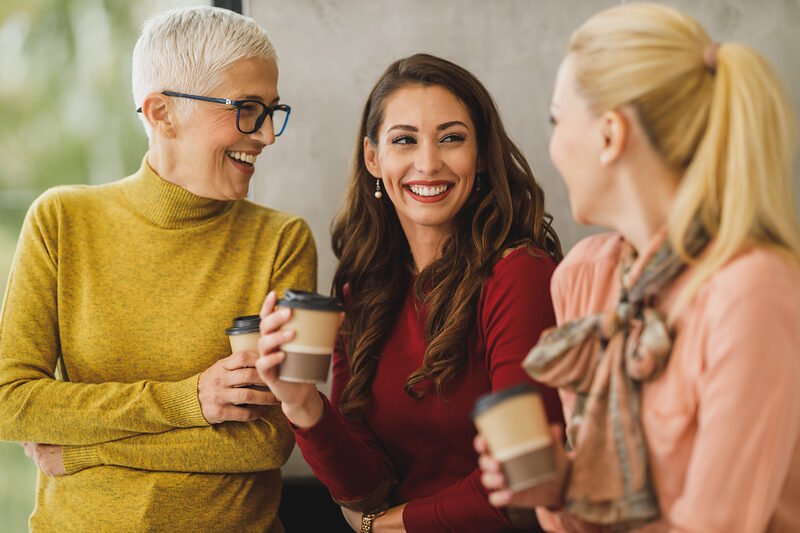 Colleagues talking during a break in a bright open office