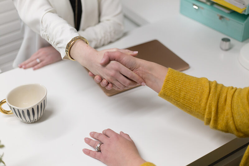 Two professionals shaking hands after a successful meeting